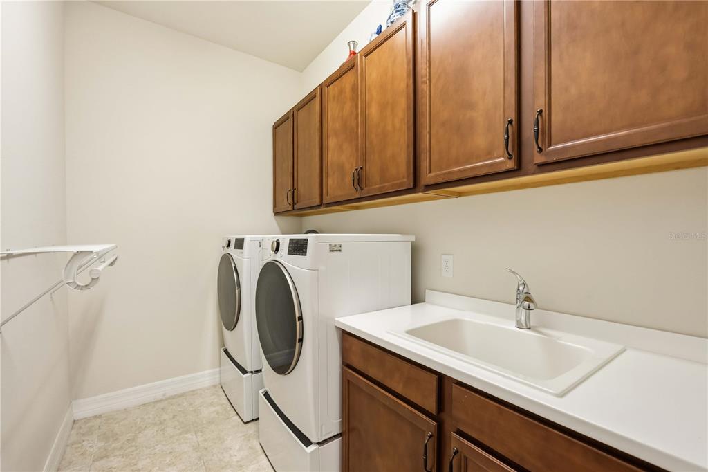 13349 Verandi Street Venice, FL 34293 - Photo 22 of 76 a utility room with sink dryer and washer
