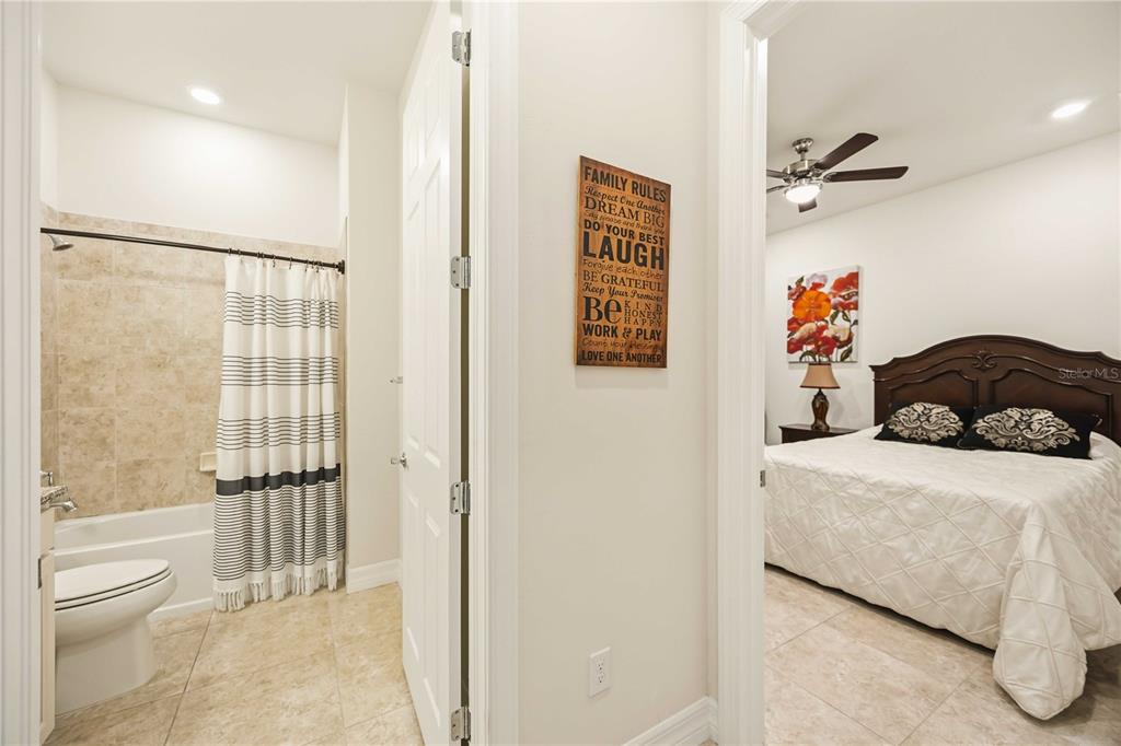 13349 Verandi Street Venice, FL 34293 - Photo 23 of 76 a bedroom with a bed and a couch