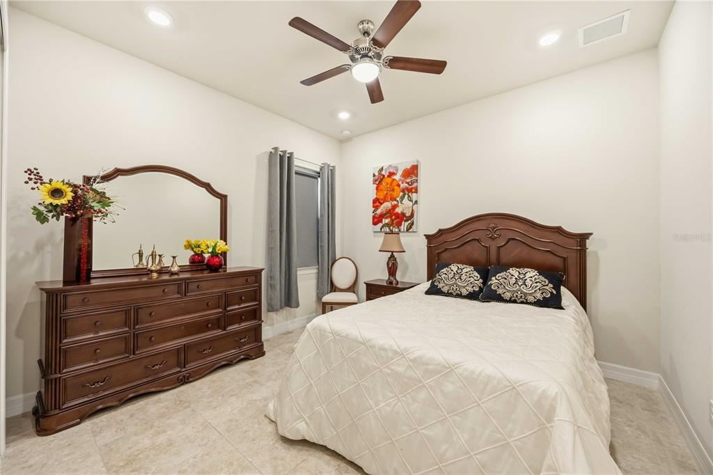 13349 Verandi Street Venice, FL 34293 - Photo 24 of 76 a bedroom with a bed and a dresser