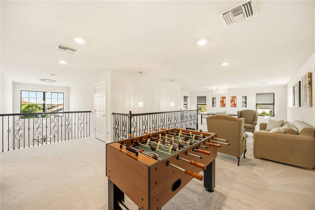 13349 Verandi Street Venice, FL 34293 - Photo 30 of 76 a living room with furniture a table and chairs