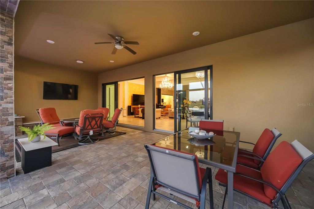 13349 Verandi Street Venice, FL 34293 - Photo 47 of 76 a living room with furniture a flat screen tv and a large window