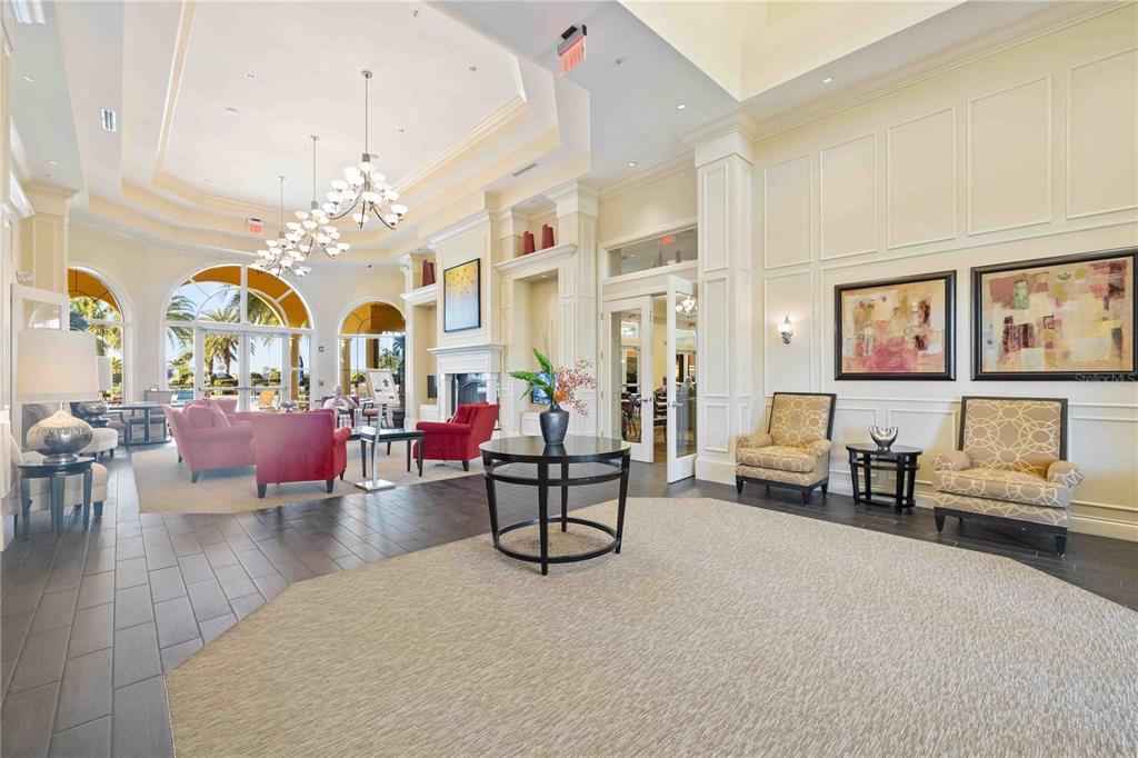 13349 Verandi Street Venice, FL 34293 - Photo 59 of 76 a living room with furniture a chandelier and a dining table