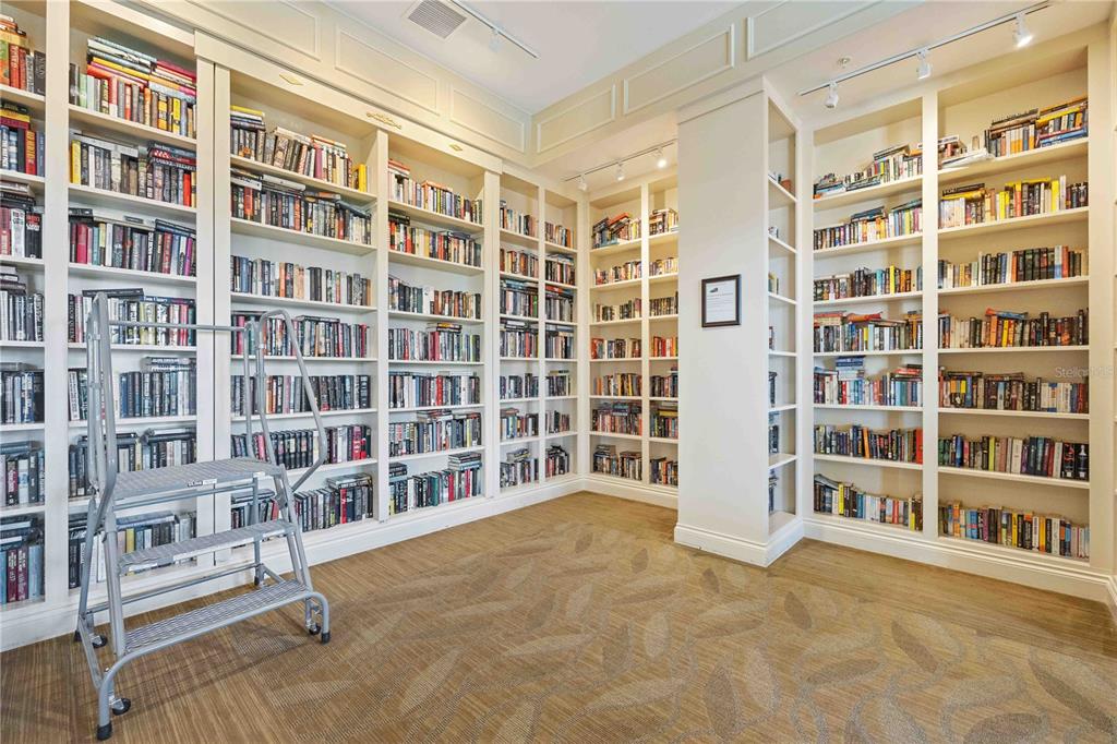 13349 Verandi Street Venice, FL 34293 - Photo 61 of 76 a view of an apartment with wooden floor and a book shelf
