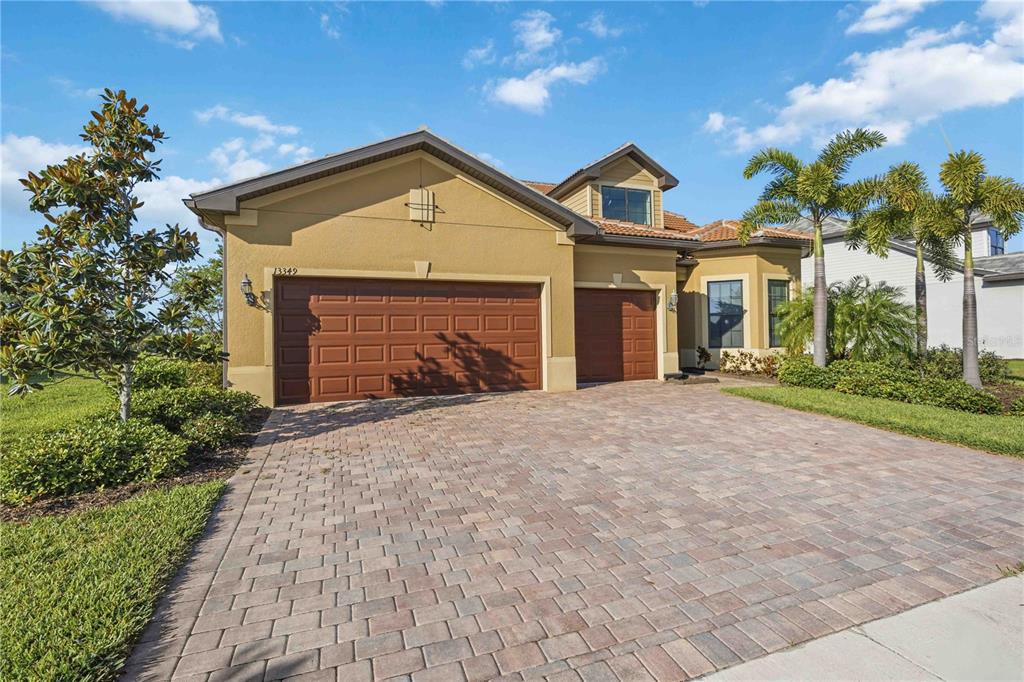 13349 Verandi Street Venice, FL 34293 - Photo 9 of 76 a front view of a house with a yard and garage
