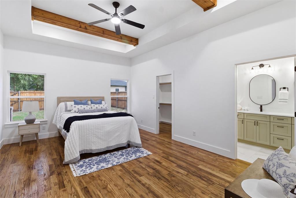 429 Waterboard Road Trinidad, TX 75163 - Photo 12 of 25 Spacious room featuring wood-finish flooring, a tray ceiling with exposed wood beams, and a ceiling fan