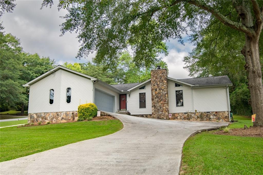 2966 Riviera Drive Conyers, GA 30012 - Photo 2 of 63 a front view of house with yard and green space