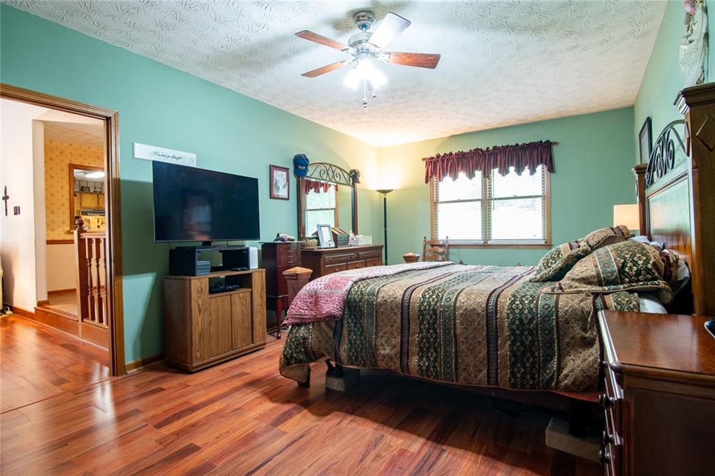 2966 Riviera Drive Conyers, GA 30012 - Photo 21 of 63 a bedroom with a bed and a flat tv screen on dresser