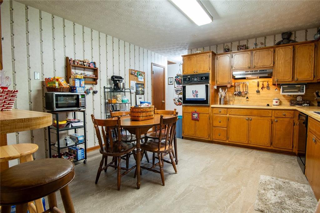 2966 Riviera Drive Conyers, GA 30012 - Photo 23 of 63 a kitchen with a table chairs sink and cabinets