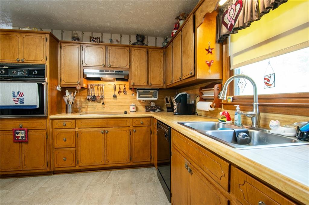 2966 Riviera Drive Conyers, GA 30012 - Photo 26 of 63 a kitchen with stainless steel appliances a sink cabinets and wooden floor