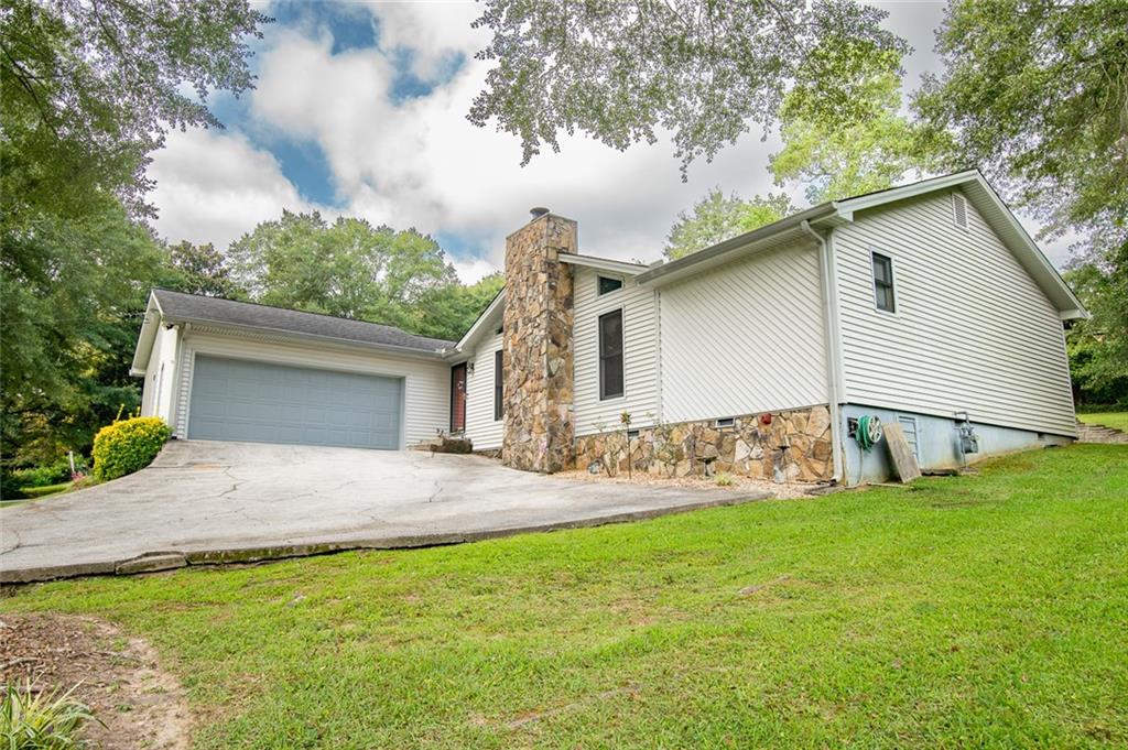 2966 Riviera Drive Conyers, GA 30012 - Photo 3 of 63 a view of a house with a yard and garage