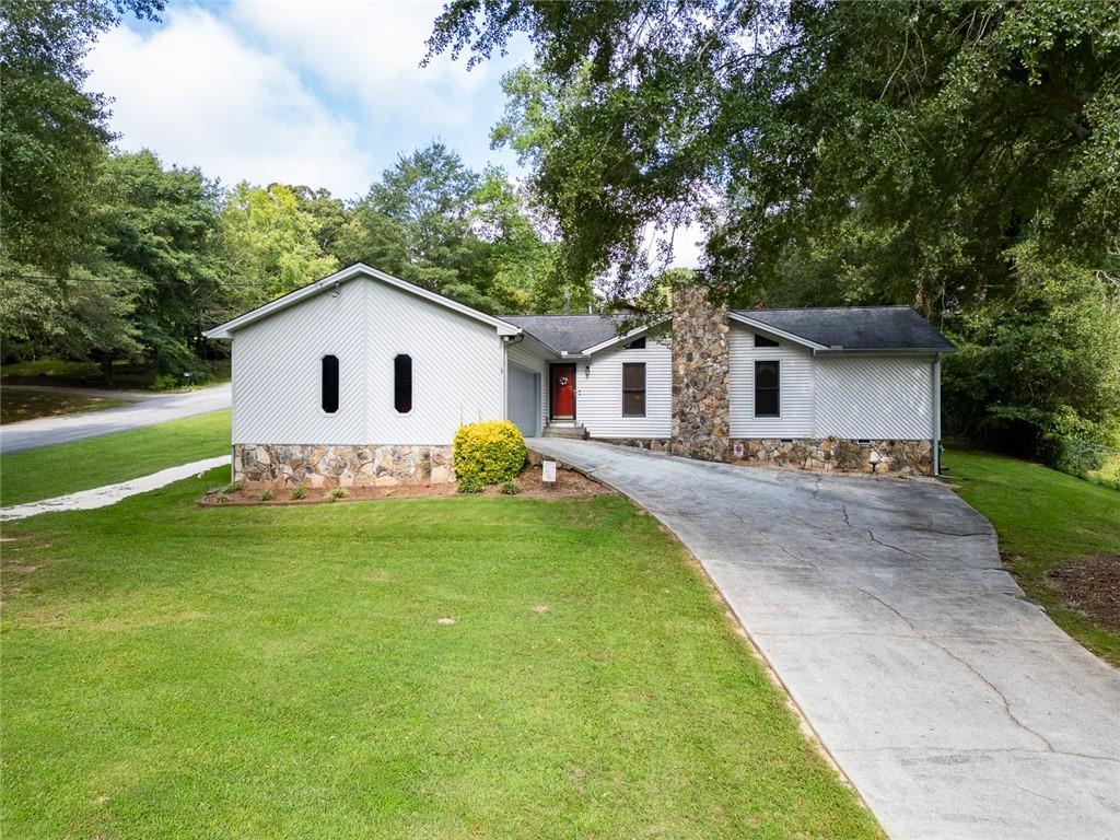 2966 Riviera Drive Conyers, GA 30012 - Photo 40 of 63 a front view of house with yard and green space