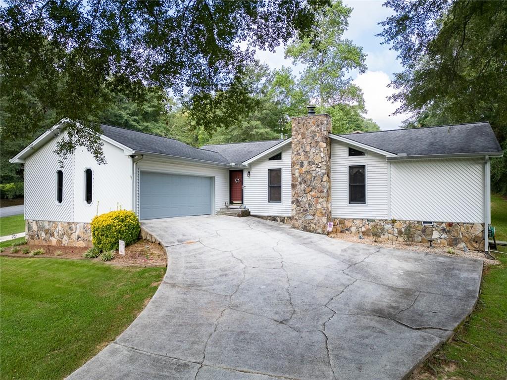 2966 Riviera Drive Conyers, GA 30012 - Photo 41 of 63 a front view of a house with a garden and yard