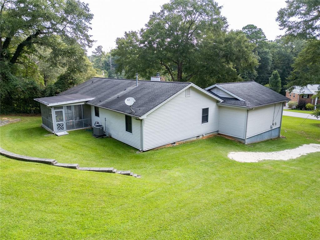 2966 Riviera Drive Conyers, GA 30012 - Photo 51 of 63 a aerial view of a house with swimming pool and big yard