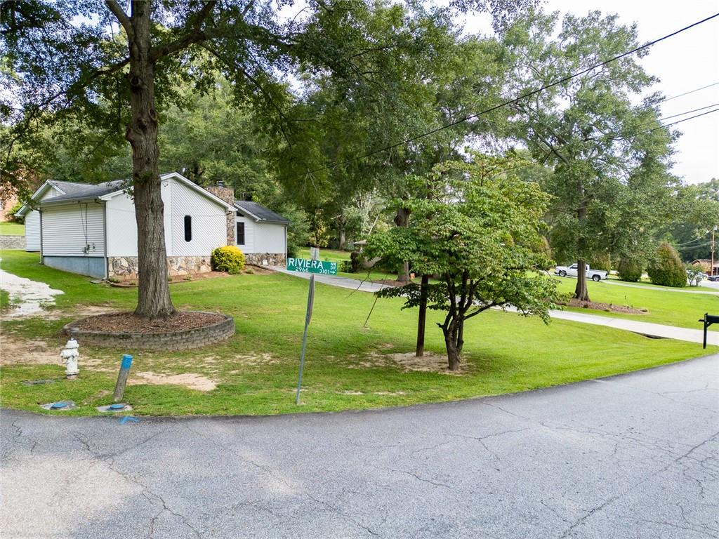 2966 Riviera Drive Conyers, GA 30012 - Photo 52 of 63 a view of a house with a big yard and large trees