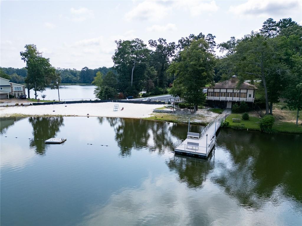2966 Riviera Drive Conyers, GA 30012 - Photo 56 of 63 a swimming pool with outdoor seating and lake
