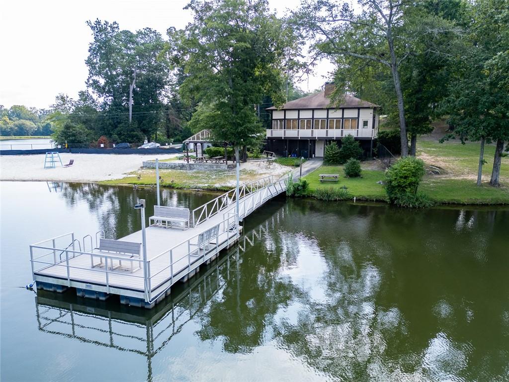 2966 Riviera Drive Conyers, GA 30012 - Photo 59 of 63 a view of a swimming pool with a bench and trees around