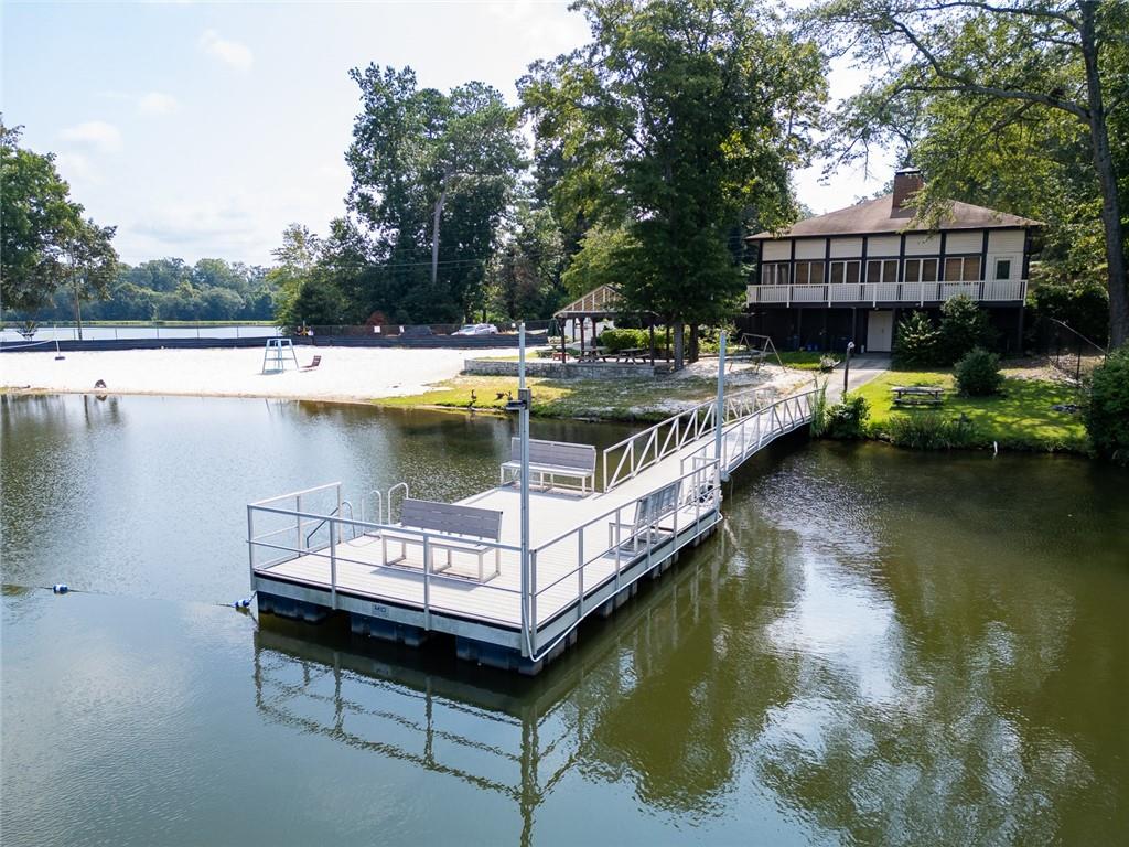 2966 Riviera Drive Conyers, GA 30012 - Photo 63 of 63 a view of a swimming pool with outdoor seating and lake view