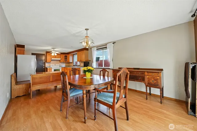 a dining room with furniture and wooden floor