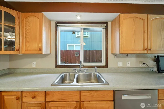 a kitchen with stainless steel appliances granite countertop a sink and a white cabinets