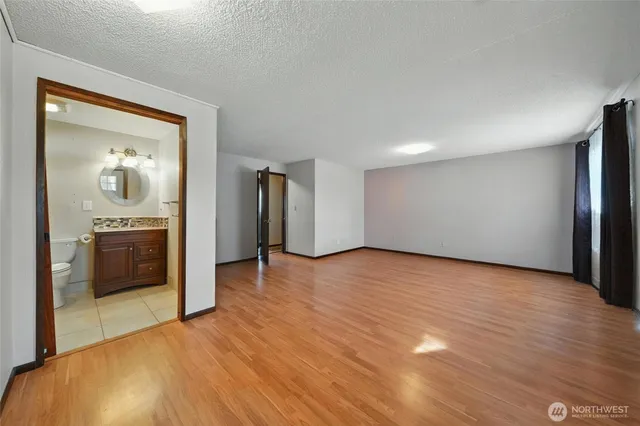a view of empty room with wooden floor