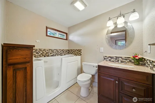 a bathroom with a toilet sink and mirror
