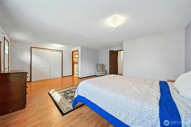 a bedroom with bed and window