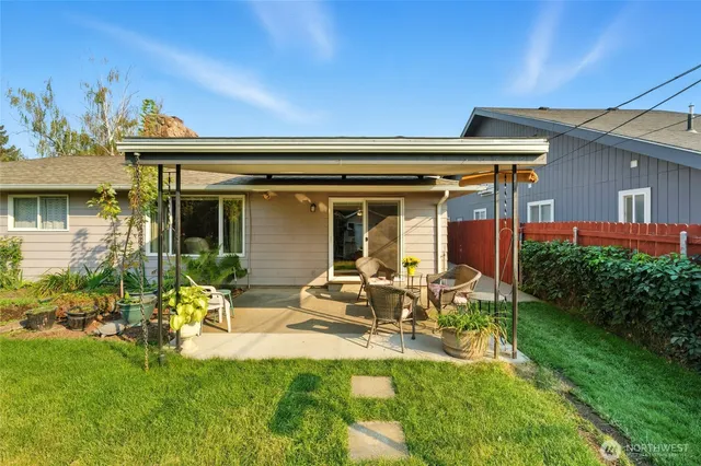 a front view of house with a garden and patio
