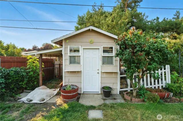 a front view of house with yard and outdoor seating
