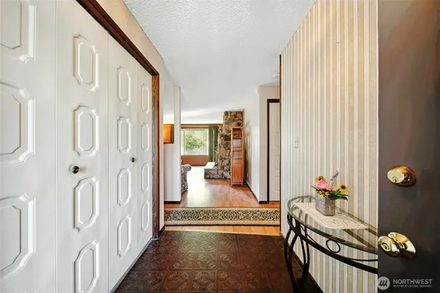 a view of a hallway and a livingroom with furniture