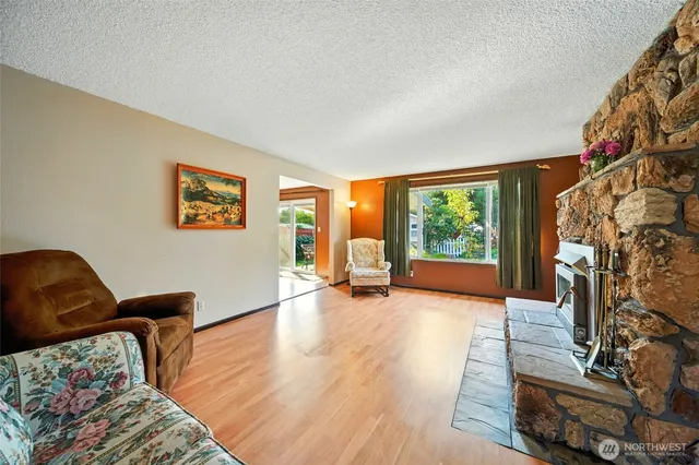 a view of a livingroom with furniture wooden floor and windows