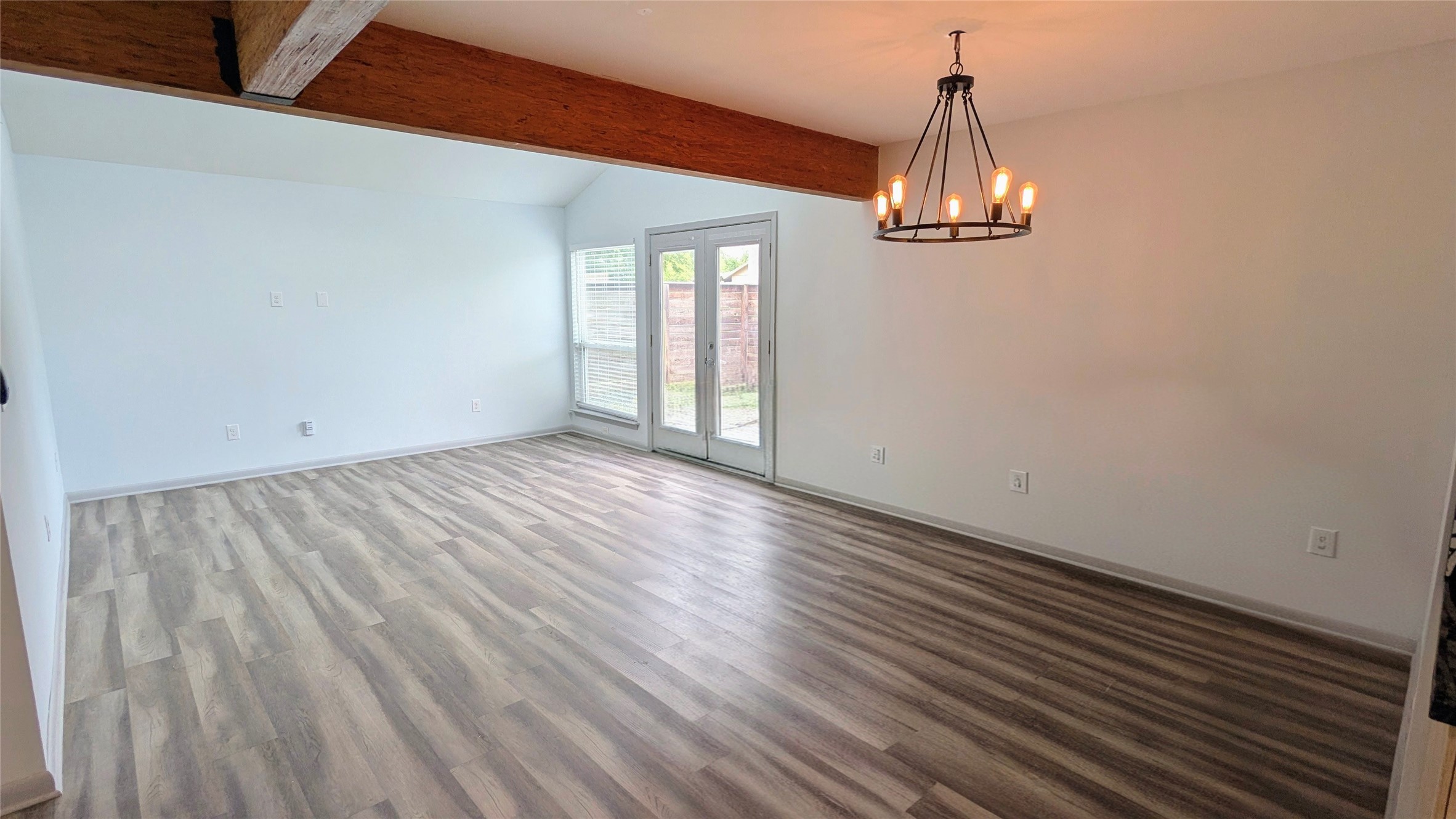 4505 Teri Road, Unit A Austin, TX 78744 - Photo 7 of 23 A striking overhead beam and modern chandelier elevate this open living space with ample natural light.