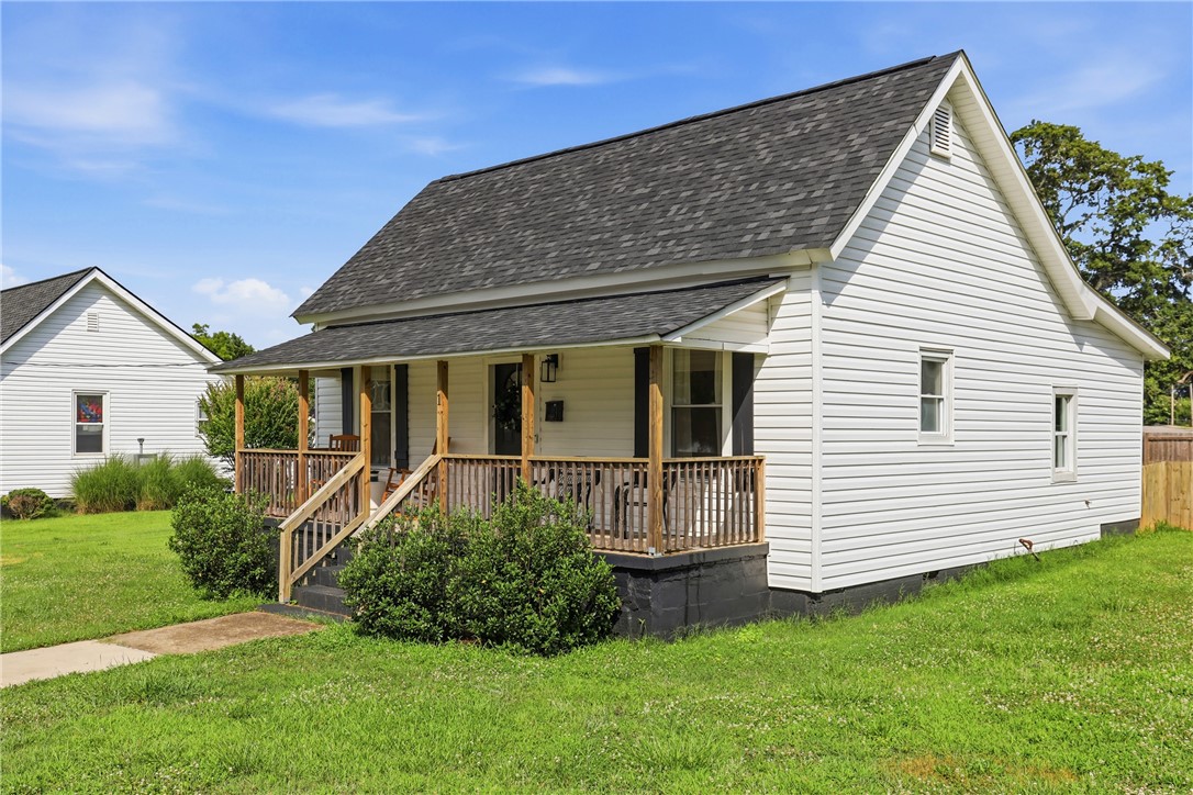 1 Brock Street Pelzer, SC 29669 - Photo 24 of 25 A classic front porch welcomes you to this charming residence with crisp white siding and a new roof.