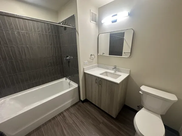 a bathroom with a sink a toilet and bathtub