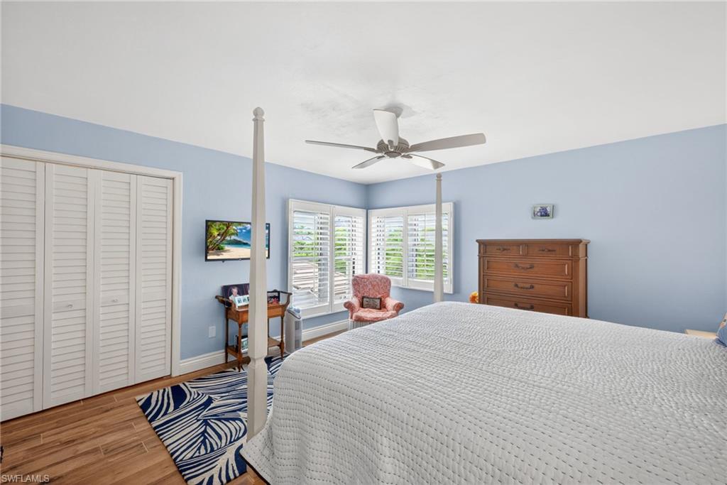 4030 Crayton Road, Unit C2 Naples, FL 34103 - Photo 22 of 32 a bedroom with a bed a window and chair