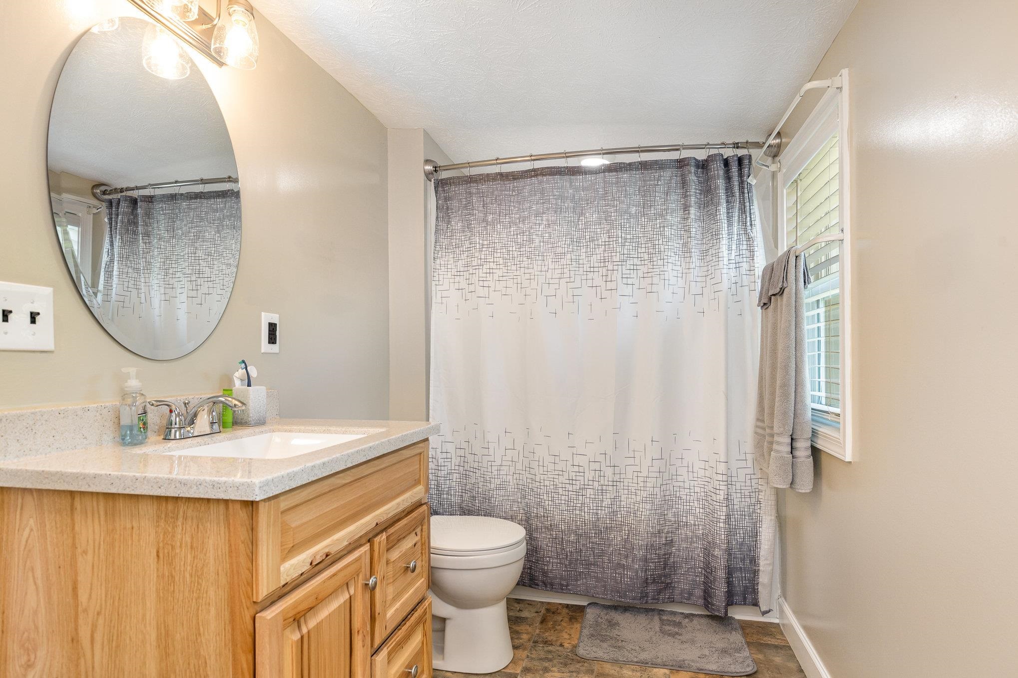 406 6th Street Luray, VA 22835 - Photo 16 of 28 a bathroom with a sink vanity mirror and toilet