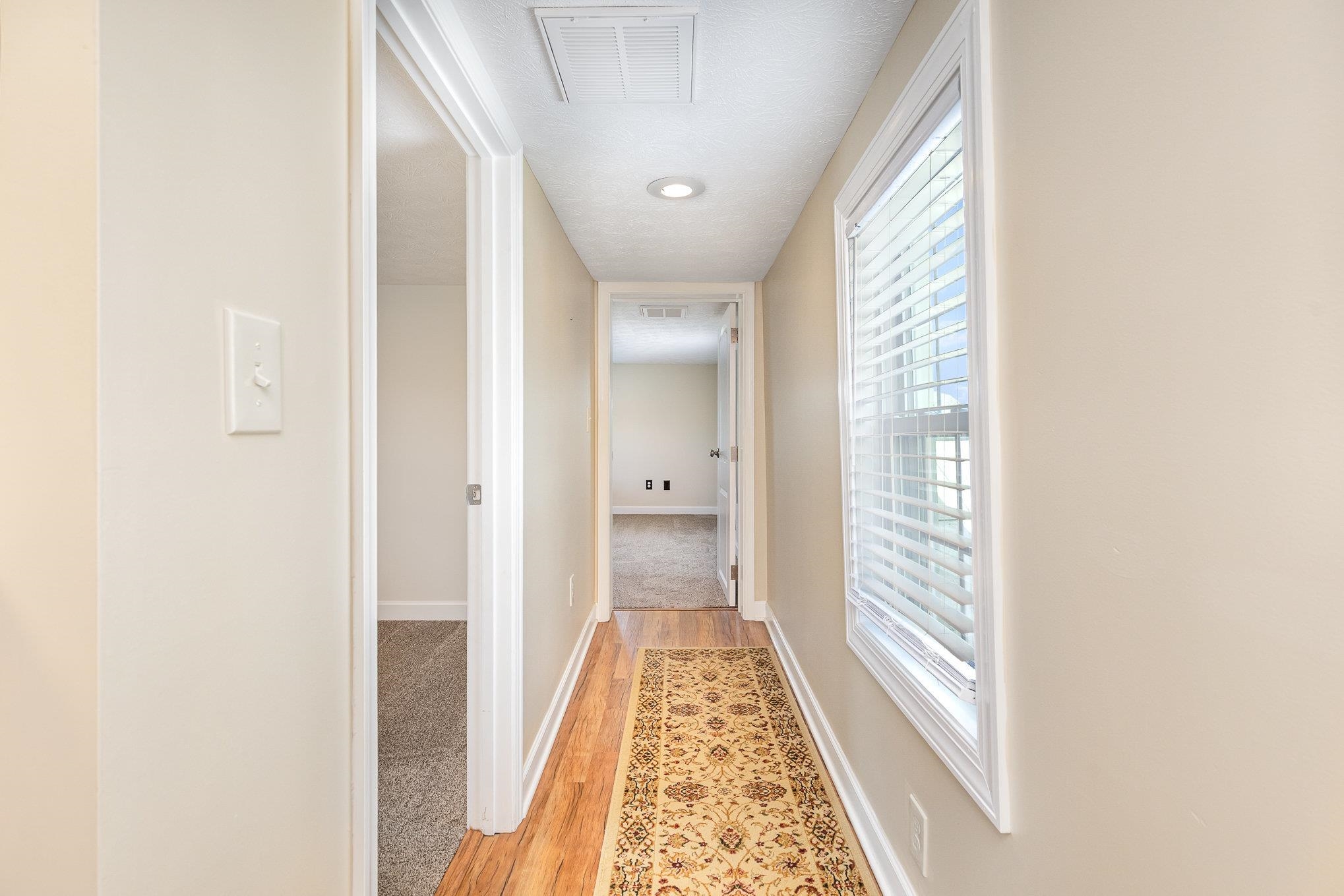 406 6th Street Luray, VA 22835 - Photo 17 of 28 a view of a hallway with wooden floor and a bathroom
