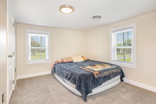 a bedroom with a bed and window