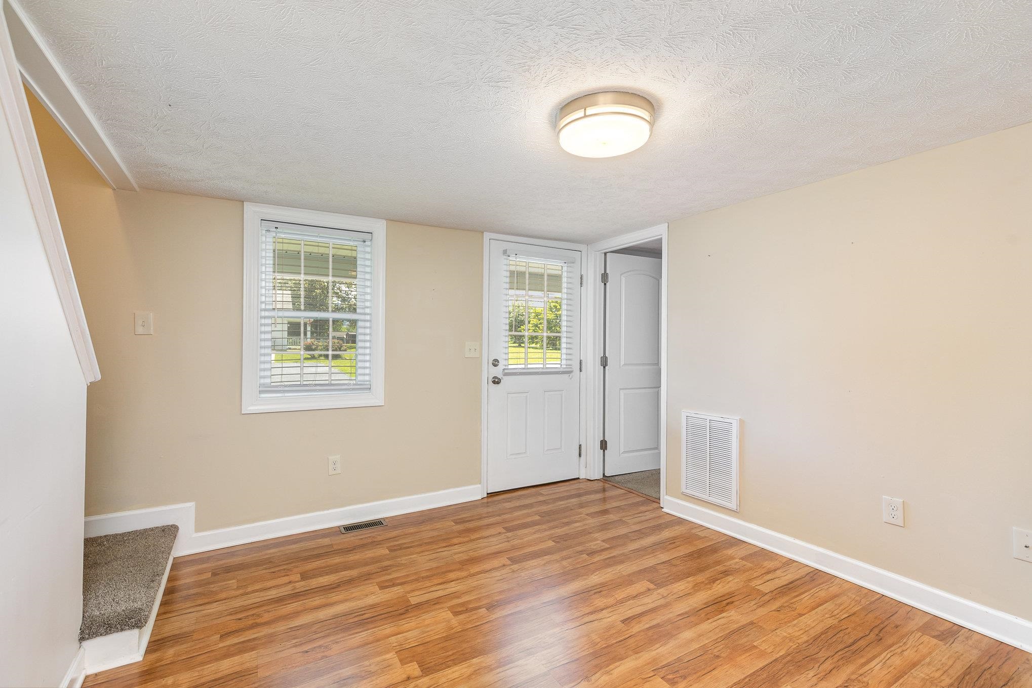 406 6th Street Luray, VA 22835 - Photo 6 of 28 an empty room with wooden floor and windows