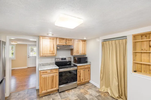 a kitchen with stainless steel appliances a stove and a refrigerator