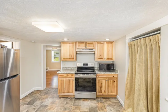 a kitchen with a stove and a refrigerator