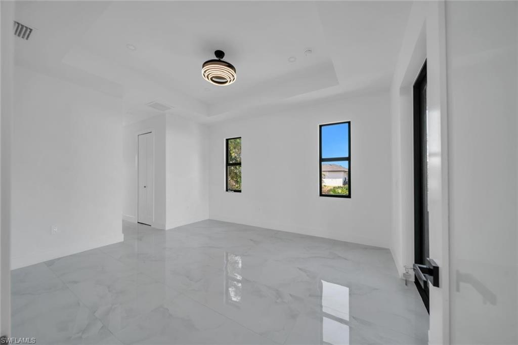 3312 17th Street Southwest Lehigh Acres, FL 33976 - Photo 8 of 12 an empty room with windows
