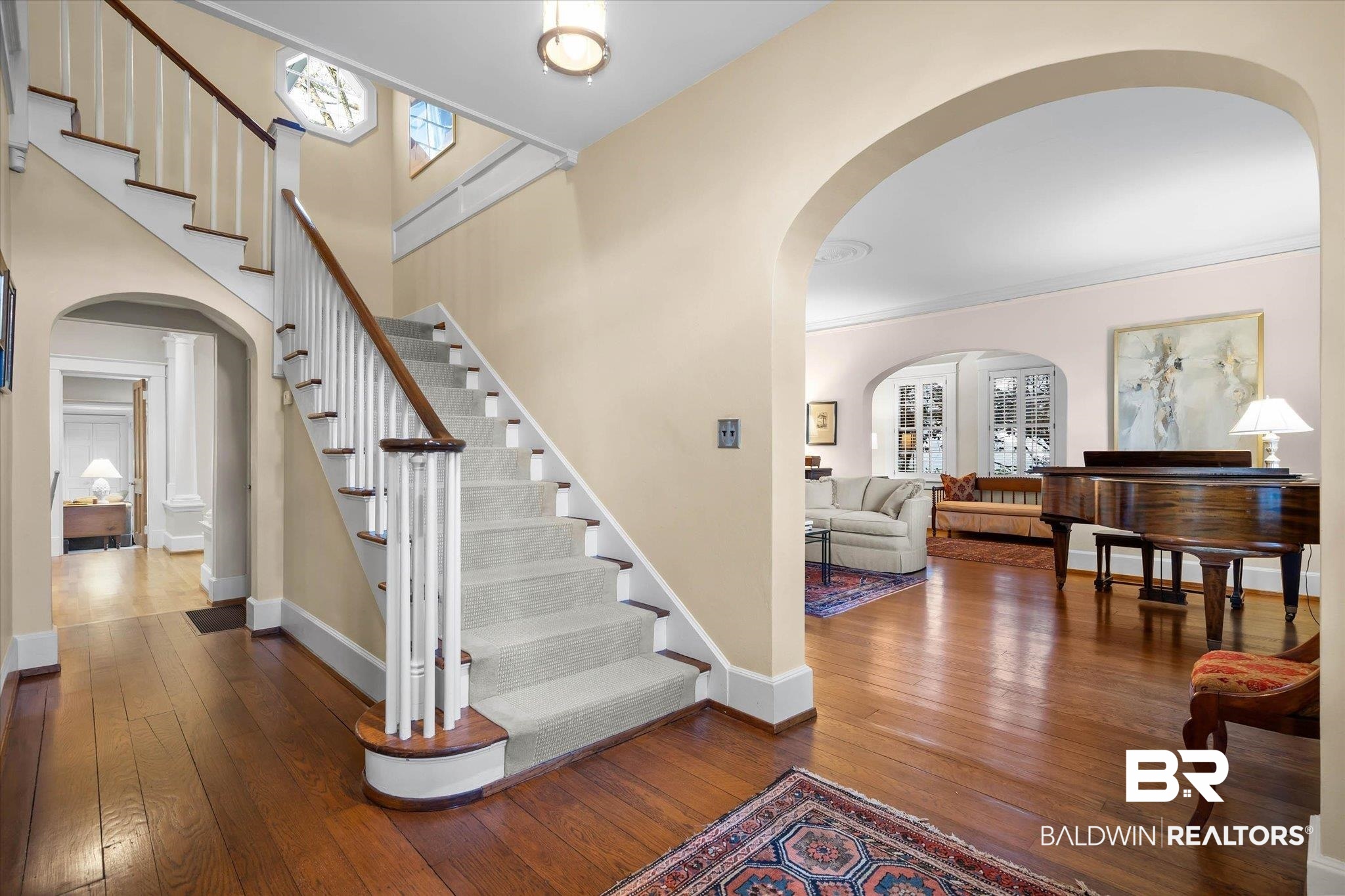 2 Westgate Road Mobile, AL 36608 - Photo 4 of 63 Foyer entrance featuring arched walkways, dark wood-type flooring, and healthy amount of natural light