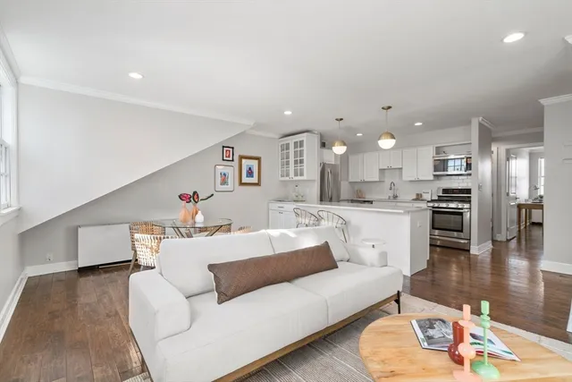 a living room with furniture and kitchen view