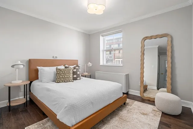 a bedroom with a bed and a chair