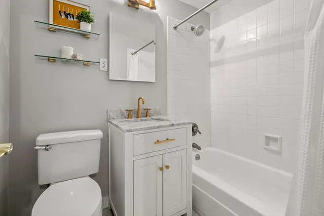 a bathroom with a toilet sink and shower