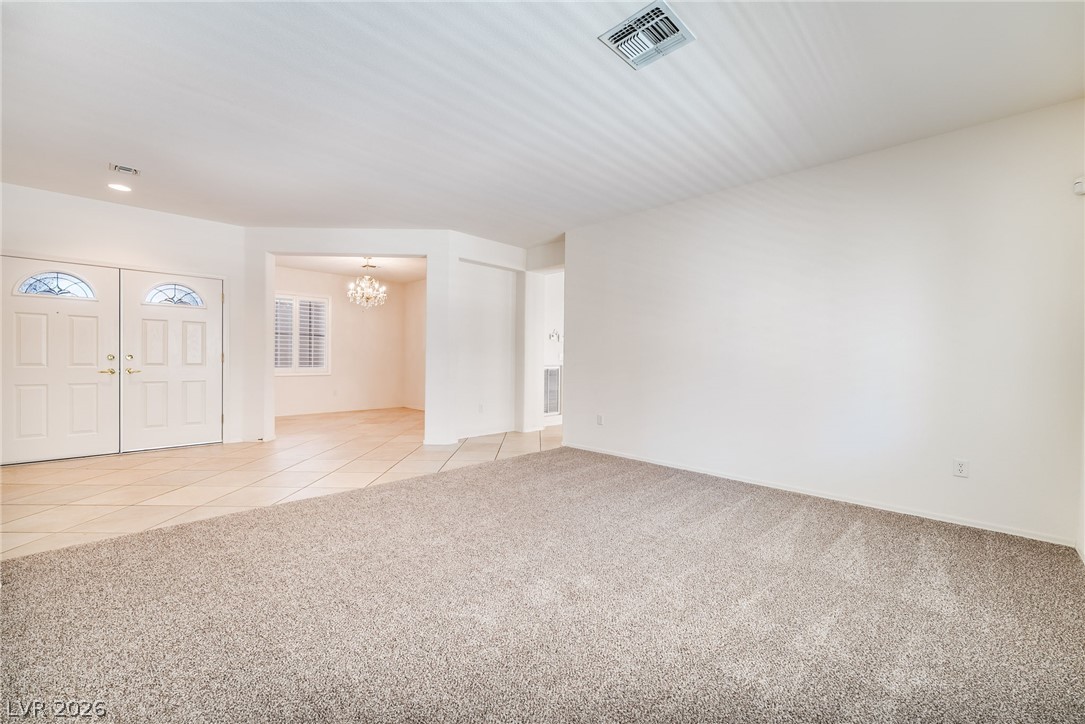 3033 Hartsville Road Henderson, NV 89052 - Photo 9 of 41 A well-lit entryway welcomes guests with elegant double doors and durable tile flooring.