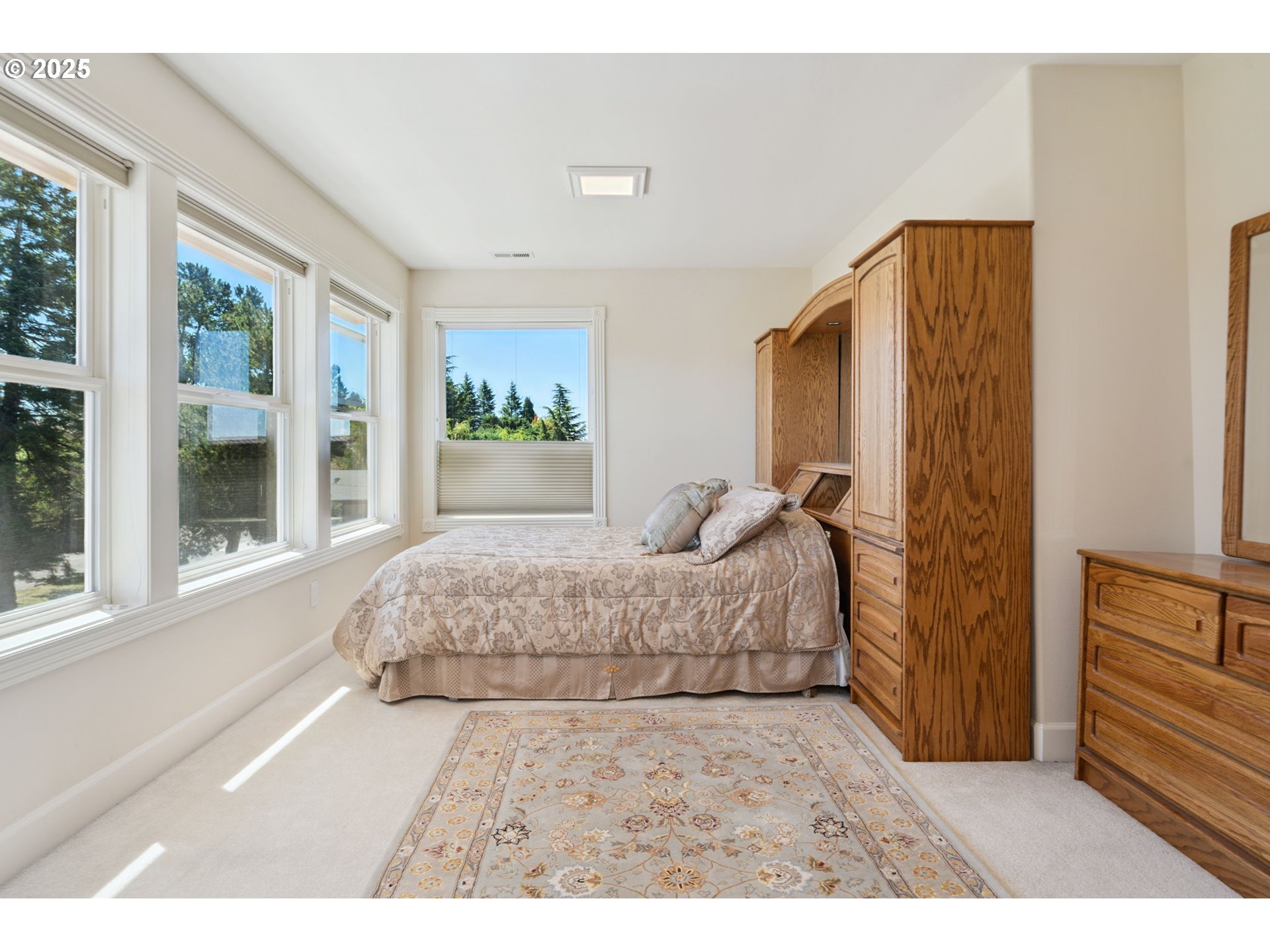 1650 Northwest Deerfern Street Camas, WA 98607 - Photo 20 of 47 a spacious bedroom with a large bed and wooden floor
