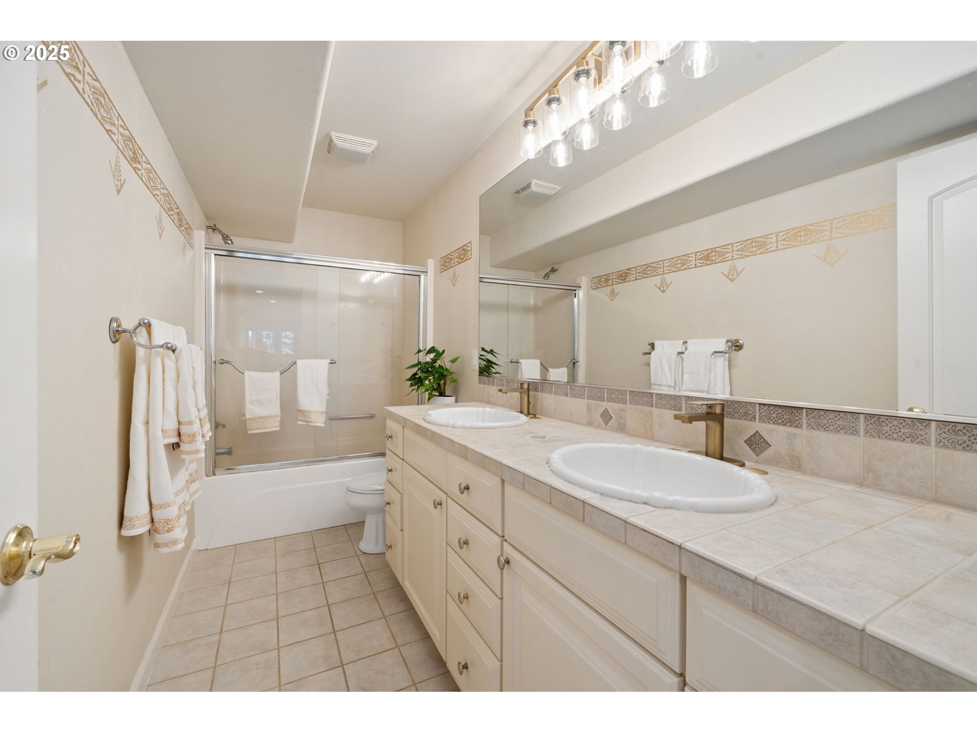 1650 Northwest Deerfern Street Camas, WA 98607 - Photo 40 of 47 a bathroom with a sink a toilet a mirror and shower