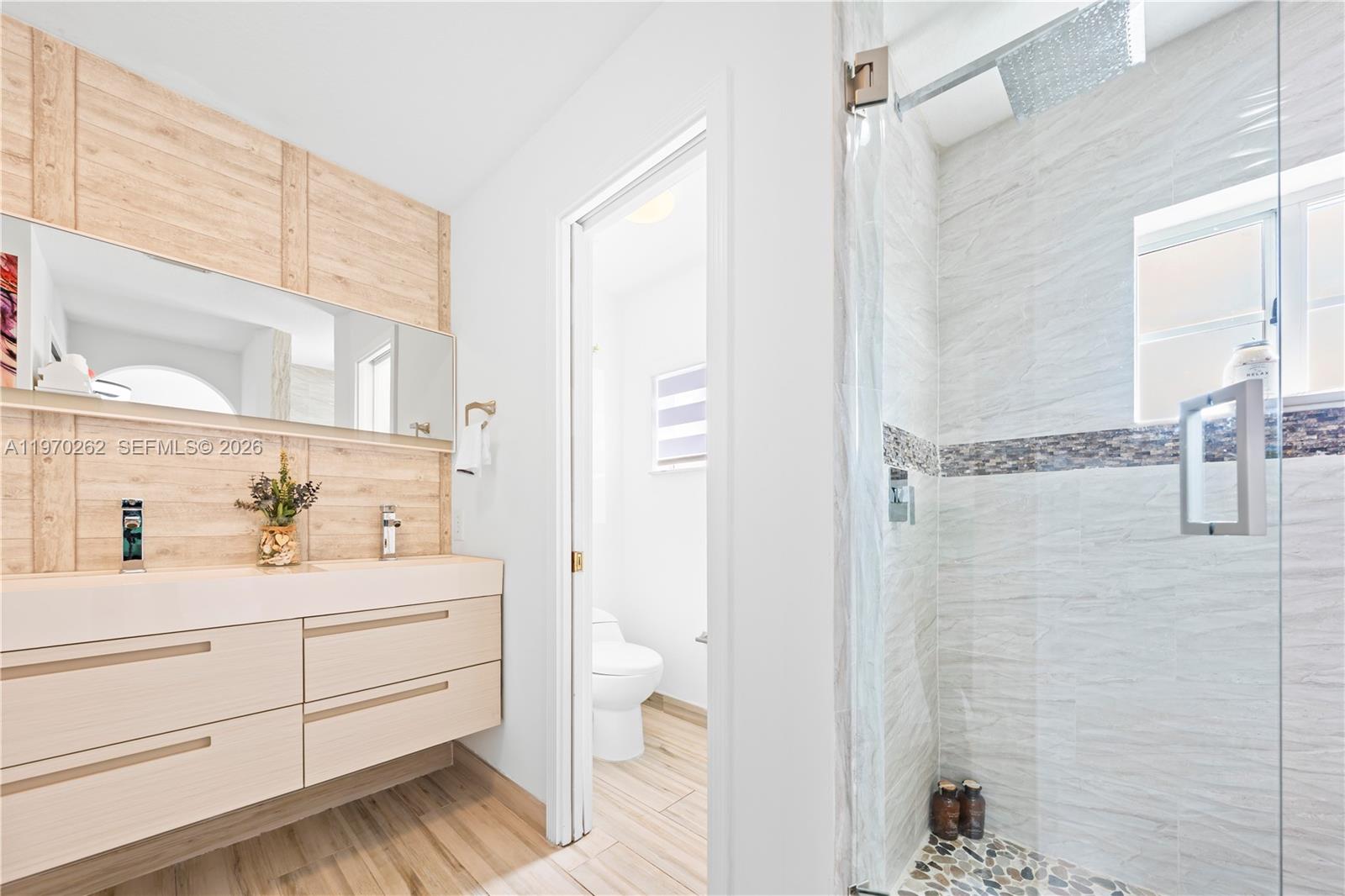 12858 Southwest 50th Street Miramar, FL 33027 - Photo 17 of 36 a bathroom with a sink a toilet and shower