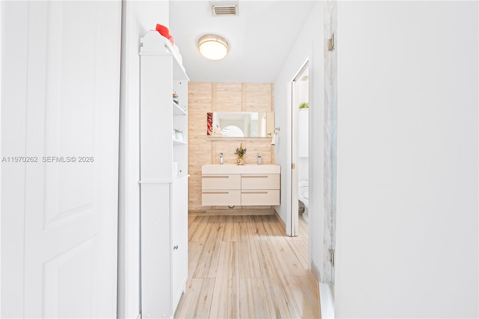 12858 Southwest 50th Street Miramar, FL 33027 - Photo 18 of 36 a view of a hallway with white cabinet
